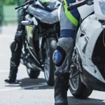 a person wearing a knee brace next to a motorcycle